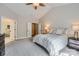This bedroom boasts vaulted ceilings, carpeted floors, and an ensuite bathroom at 1455 Moss Creek Dr, Harrisburg, NC 28075