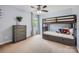 Cozy bedroom with a bunk bed, soft carpet, and a serene atmosphere with a plant on the dresser at 1455 Moss Creek Dr, Harrisburg, NC 28075