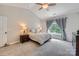 This bedroom boasts vaulted ceilings, carpeted floors, and a window with beautiful gray curtains at 1455 Moss Creek Dr, Harrisburg, NC 28075