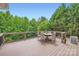 Outdoor deck with comfortable seating and lush greenery, perfect for relaxation and entertaining at 1455 Moss Creek Dr, Harrisburg, NC 28075