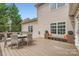 A view of the outdoor deck with dining set and additional bench seating at 1455 Moss Creek Dr, Harrisburg, NC 28075