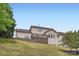 Exterior view of a home with a spacious deck, well-maintained lawn, and inviting curb appeal at 1455 Moss Creek Dr, Harrisburg, NC 28075