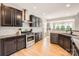 Modern kitchen featuring granite countertops, stainless steel appliances, and wooden floors at 1455 Moss Creek Dr, Harrisburg, NC 28075