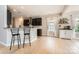 Open kitchen and breakfast bar with granite counters, stainless appliances and light-filled eating area at 1455 Moss Creek Dr, Harrisburg, NC 28075