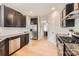 Well-lit kitchen showcasing stainless steel appliances, granite countertops, and light wood floors at 1455 Moss Creek Dr, Harrisburg, NC 28075