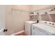 Laundry room featuring a washer and dryer and wire shelving at 1455 Moss Creek Dr, Harrisburg, NC 28075