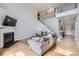 Spacious living room featuring hardwood floors, a fireplace, and an open staircase to the upper level at 1455 Moss Creek Dr, Harrisburg, NC 28075