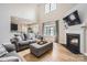 Inviting living room featuring a fireplace, hardwood floors, and an abundance of natural light at 1455 Moss Creek Dr, Harrisburg, NC 28075