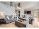 Open-concept living room with high ceilings and light-filled space connected to kitchen and stairs at 1455 Moss Creek Dr, Harrisburg, NC 28075