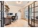 This office has hardwood floors, a rustic brick wall, a wooden desk, and black framed windows for great light at 1455 Moss Creek Dr, Harrisburg, NC 28075