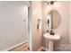 Powder room features a pedestal sink and wood flooring at 1455 Moss Creek Dr, Harrisburg, NC 28075