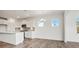 Modern kitchen featuring white cabinets, stainless steel appliances, and an eat-in dining area with wood flooring at 15012 Meadows Hunt Ln # 157, Huntersville, NC 28078