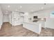 Spacious kitchen with a large island, white cabinetry, and stainless steel appliances, perfect for entertaining at 15012 Meadows Hunt Ln # 157, Huntersville, NC 28078