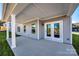 Covered back porch, complete with access to the home's interior through a set of double doors at 18011 Wilbanks Dr, Charlotte, NC 28278
