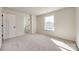 Well-lit bedroom with neutral carpet, closet, and neighborhood view from a window at 18011 Wilbanks Dr, Charlotte, NC 28278