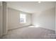 Well-lit bedroom with neutral carpeting, offering a great view of the neighborhood at 18011 Wilbanks Dr, Charlotte, NC 28278
