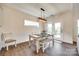 Comfortable dining area with a modern table, bench seating and natural light through the french doors at 18011 Wilbanks Dr, Charlotte, NC 28278