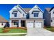 Charming two-story home featuring stone accents, a two-car garage, and well-maintained landscaping at 18011 Wilbanks Dr, Charlotte, NC 28278