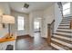 Inviting foyer with hardwood floors, a staircase with iron railings, and ample natural light at 18011 Wilbanks Dr, Charlotte, NC 28278