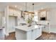 Modern kitchen with white cabinets, stainless steel appliances, and a spacious center island at 18011 Wilbanks Dr, Charlotte, NC 28278