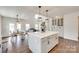 Bright, open kitchen with a large center island, modern lighting, and stainless steel appliances at 18011 Wilbanks Dr, Charlotte, NC 28278