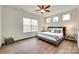 Bright main bedroom with wood-look floors and natural light from the many windows at 18011 Wilbanks Dr, Charlotte, NC 28278