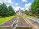 A large lawn with garden beds leads up to a beautiful home at 2020 White Cedar Ln, Waxhaw, NC 28173