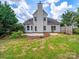 Large backyard with patio and well-manicured lawn and trees at 2020 White Cedar Ln, Waxhaw, NC 28173