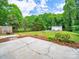 An expansive backyard featuring a wooded treeline, a storage shed, and a fire pit at 2020 White Cedar Ln, Waxhaw, NC 28173