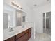 Bright bathroom features a dual sink vanity, large mirror, and walk-in closet at 2020 White Cedar Ln, Waxhaw, NC 28173