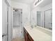 Bright bathroom featuring a white vanity, large mirror, and access to the bedroom at 2020 White Cedar Ln, Waxhaw, NC 28173