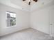 Sunlit bedroom with ceiling fan and a view, creating a relaxing atmosphere at 2020 White Cedar Ln, Waxhaw, NC 28173