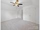 A bedroom featuring carpet, a window, a ceiling fan, and a closet at 2020 White Cedar Ln, Waxhaw, NC 28173