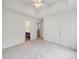 Bedroom with tray ceiling and ensuite bathroom visible in doorway at 2020 White Cedar Ln, Waxhaw, NC 28173