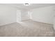 Spacious bonus room with carpeting and neutral color palette, perfect for customization at 2020 White Cedar Ln, Waxhaw, NC 28173