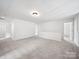 Large bonus room offering versatile space with carpeting and neutral color palette at 2020 White Cedar Ln, Waxhaw, NC 28173