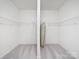 Spacious walk-in closet providing ample storage with shelving and carpeted floor at 2020 White Cedar Ln, Waxhaw, NC 28173
