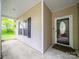 Inviting covered porch featuring a decorative glass door and a neutral exterior color palette at 2020 White Cedar Ln, Waxhaw, NC 28173