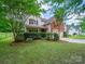 Charming two-story home featuring a manicured lawn, mature trees, and a welcoming front porch at 2020 White Cedar Ln, Waxhaw, NC 28173