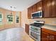 Bright eat-in kitchen features stainless steel appliances and lovely hanging light fixture over the dining area at 2020 White Cedar Ln, Waxhaw, NC 28173