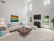 Bright living room with high ceilings, a cozy fireplace, and stylish neutral decor at 2020 White Cedar Ln, Waxhaw, NC 28173