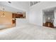 Open living space featuring a view into the kitchen with ample natural light and neutral tones at 2020 White Cedar Ln, Waxhaw, NC 28173