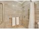 This bathroom features a walk-in shower with grab bars and neutral tile at 2915 Cherry Blossom Ct, Fort Mill, SC 29715