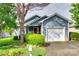 Charming blue house with a well-manicured lawn, attached garage, and inviting curb appeal at 2915 Cherry Blossom Ct, Fort Mill, SC 29715