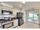 Modern kitchen featuring tile flooring, stainless steel appliances, and sliding doors to patio at 2915 Cherry Blossom Ct, Fort Mill, SC 29715