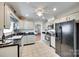 Well-lit kitchen with white cabinets, black countertops, and modern appliances at 2915 Cherry Blossom Ct, Fort Mill, SC 29715