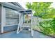Cozy covered porch with charming white swing and adjacent well-lit living space at 2915 Cherry Blossom Ct, Fort Mill, SC 29715