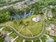 Aerial view showcasing the neighborhood's landscaping and a community pool and pond at 320 Eden Hollow Ln, Weddington, NC 28104