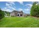 Expansive backyard with a well-maintained lawn, patio, and fire pit area at 320 Eden Hollow Ln, Weddington, NC 28104
