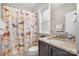 Bathroom with a single sink vanity, framed mirror and dog-themed shower curtain at 320 Eden Hollow Ln, Weddington, NC 28104